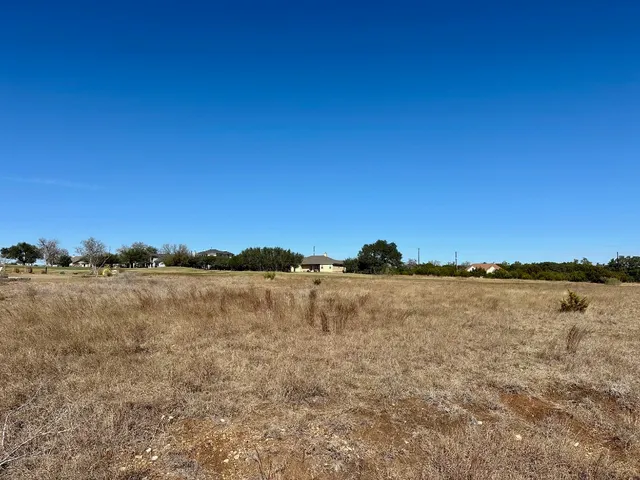 a view of house with backyard and outdoor seating