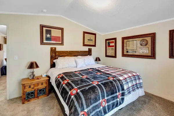 a bedroom with bed and painting on the wall