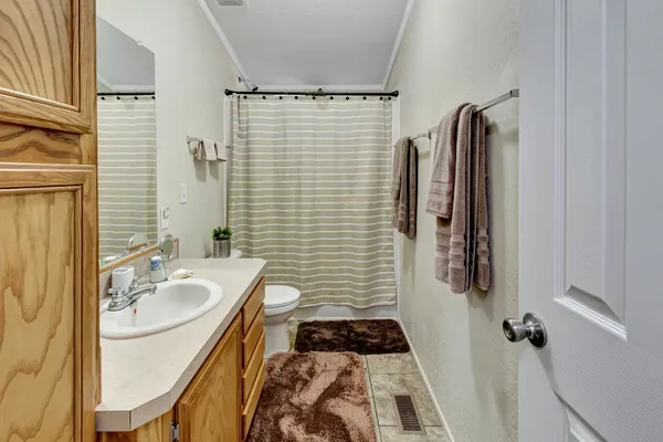 a bathroom with a sink a mirror and shower