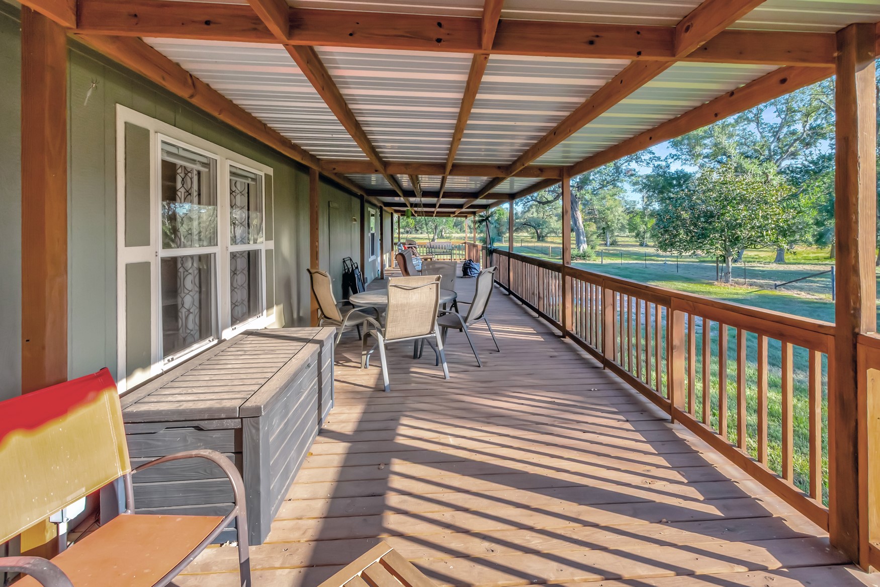 2698 County Road 284 Edna, TX 77957 - Photo 22 of 41 a view of a patio with table and chairs with wooden floor and fence