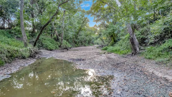 a big yard with lots of green space and deers