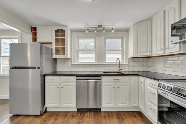a kitchen with stainless steel appliances granite countertop a refrigerator sink and cabinets