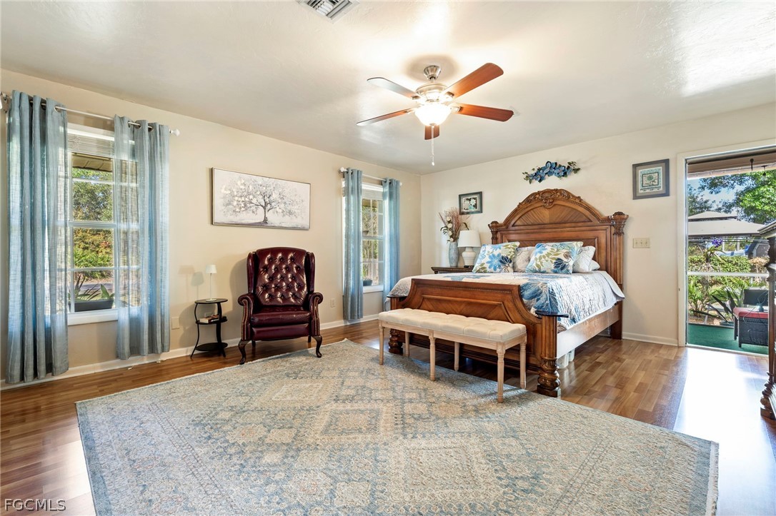 2724 3rd Street Southwest Lehigh Acres, FL 33976 - Photo 11 of 26 a bedroom with a bed and a chandelier