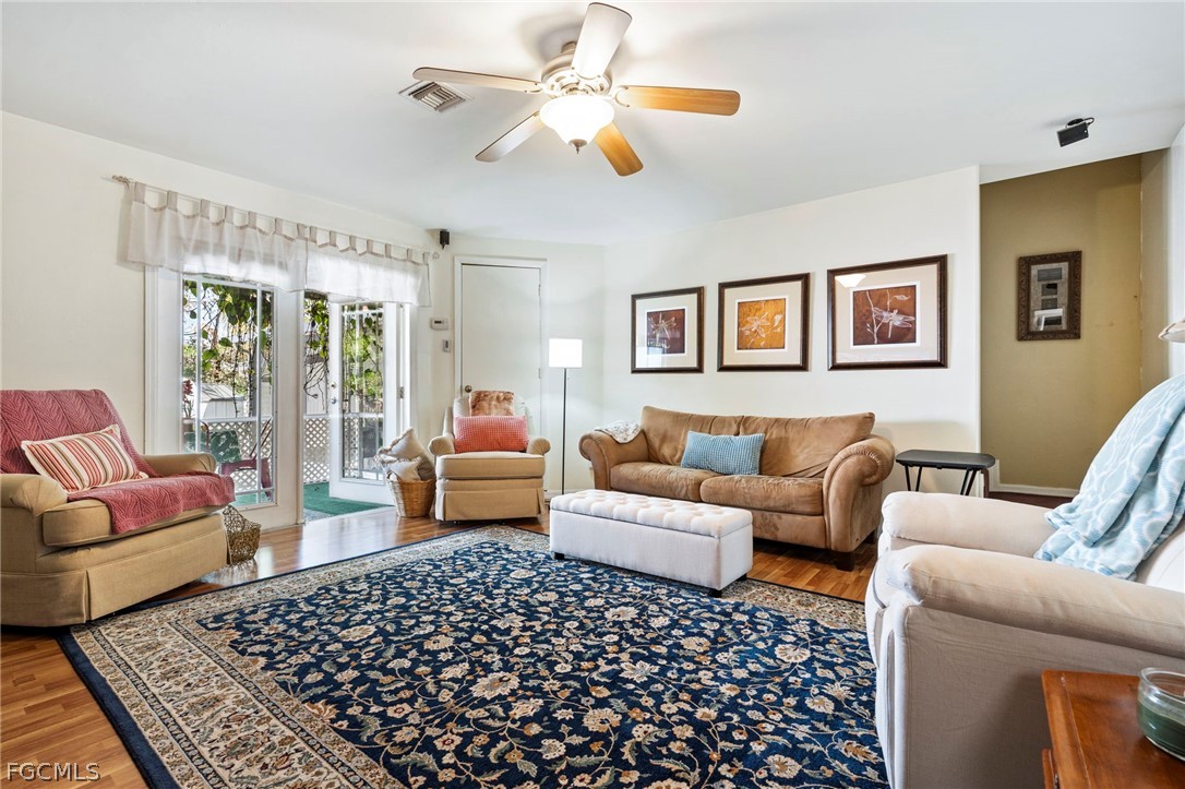 2724 3rd Street Southwest Lehigh Acres, FL 33976 - Photo 22 of 26 a living room with furniture ceiling fan and a rug