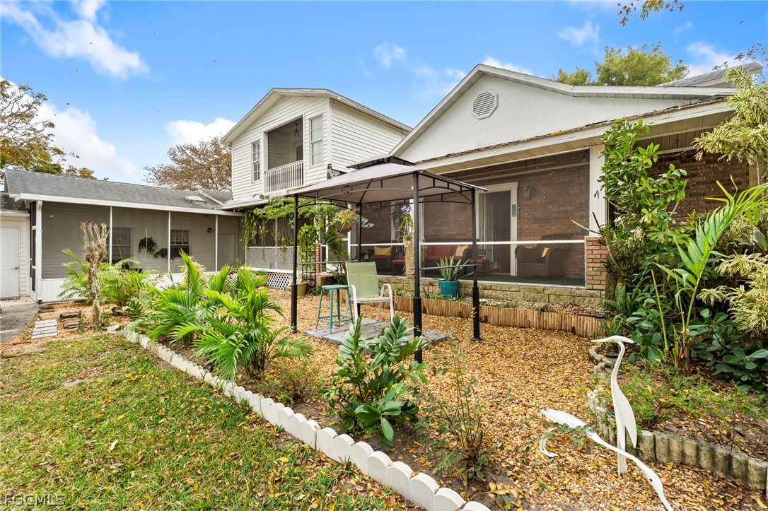 2724 3rd Street Southwest Lehigh Acres, FL 33976 - Photo 3 of 26 a front view of a house with garden