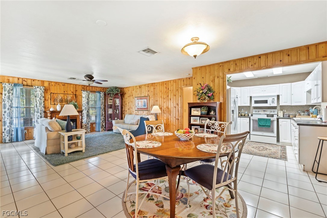 2724 3rd Street Southwest Lehigh Acres, FL 33976 - Photo 5 of 26 a view of a dining room with furniture window and outside view