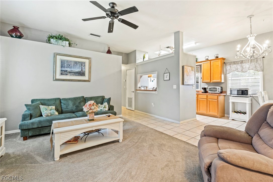 2724 3rd Street Southwest Lehigh Acres, FL 33976 - Photo 9 of 26 a living room with furniture and a chandelier