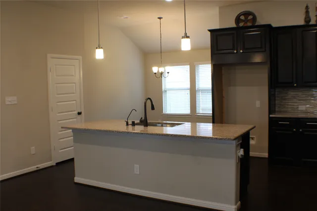 a kitchen with cabinets and window