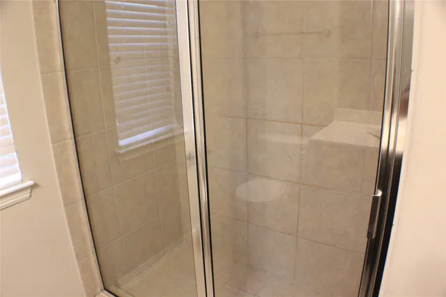 a bathroom with a glass shower door
