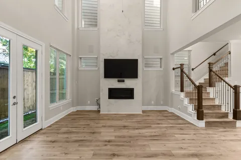 a view of a livingroom with wooden floor and a flat screen tv