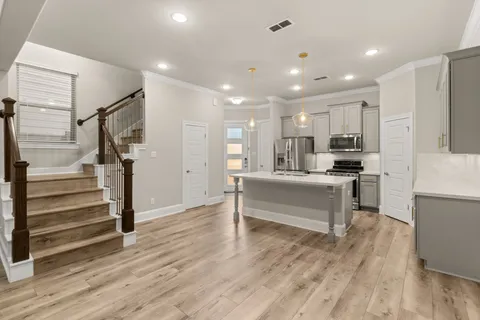 a view of kitchen with counter top space and refrigerator
