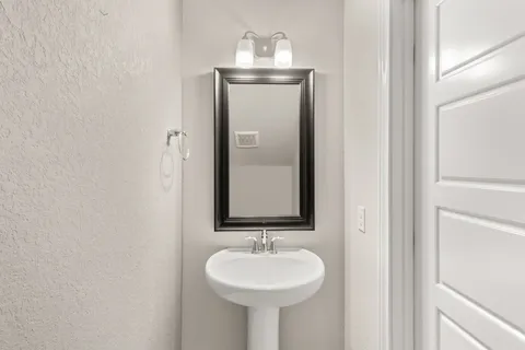 a bathroom with a sink and a mirror