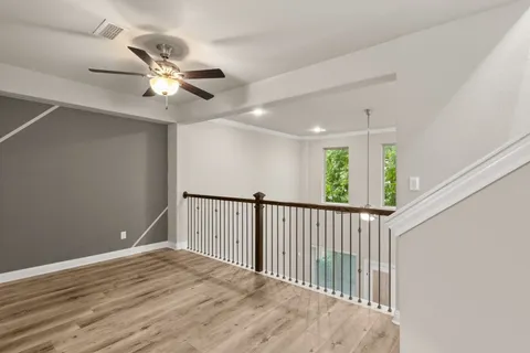 a view of empty room with wooden floor