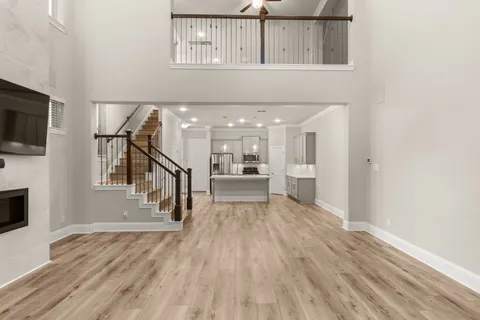 a view of a kitchen with wooden floor and a window