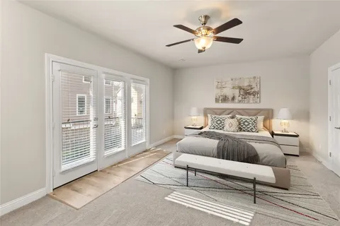 a spacious bedroom with a bed and a large window