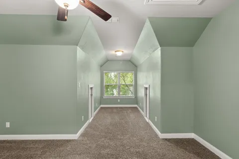 an entryway of a house with wooden floor windows and a ceiling fan