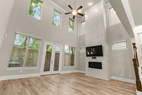 a view of a livingroom with wooden floor and a ceiling fan