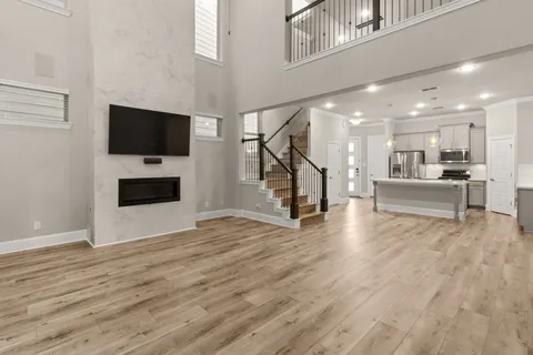 a view of a livingroom with wooden floor and a fireplace