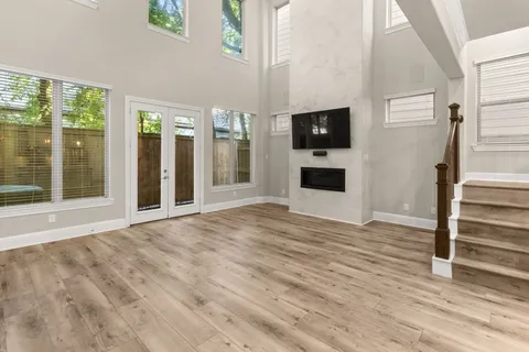 a view of a livingroom with wooden floor and a flat screen tv
