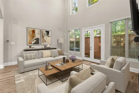 a living room with furniture and large windows