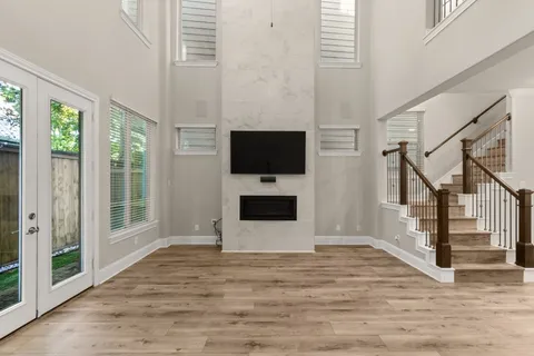 a view of a livingroom with wooden floor and a flat screen tv