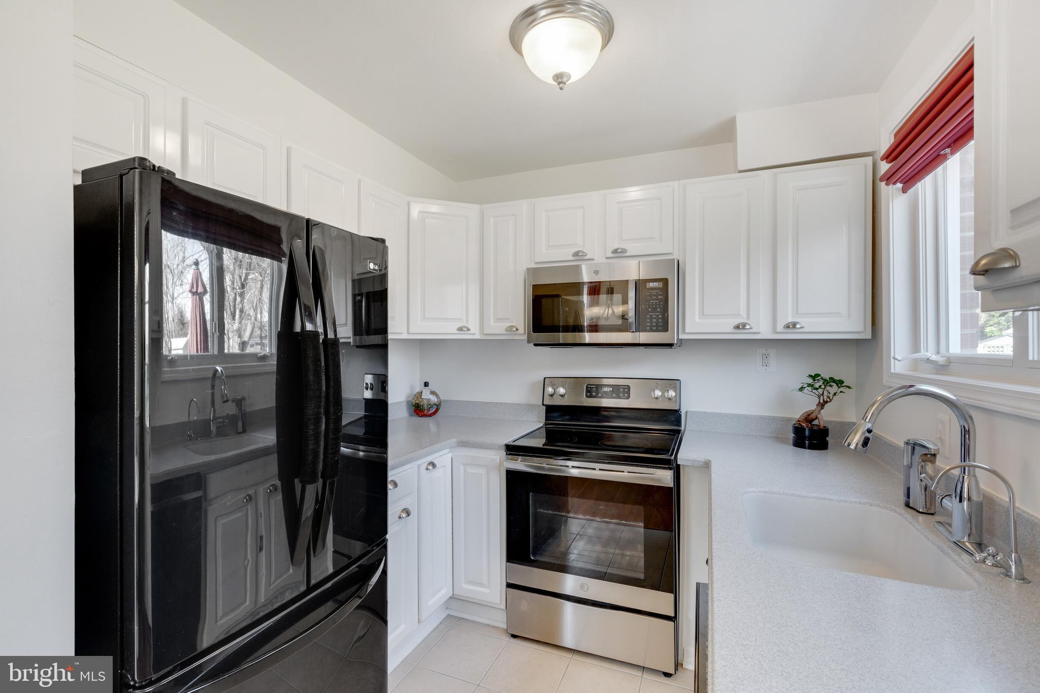 3903 Gannon Road Silver Spring, MD 20902 - Photo 12 of 51 a kitchen with stainless steel appliances a refrigerator stove and microwave