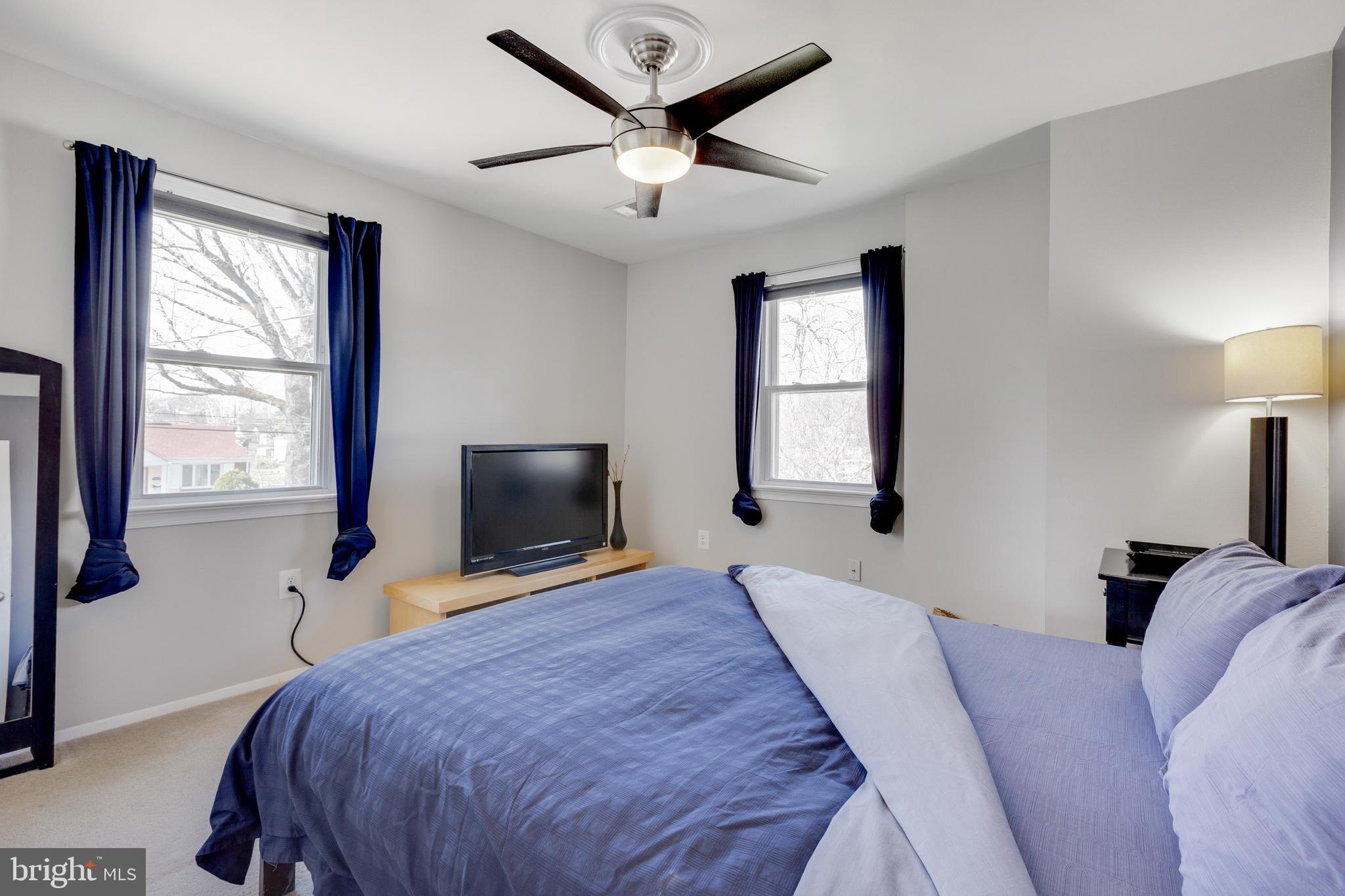 3903 Gannon Road Silver Spring, MD 20902 - Photo 16 of 51 a bedroom with a bed window and a flat screen tv