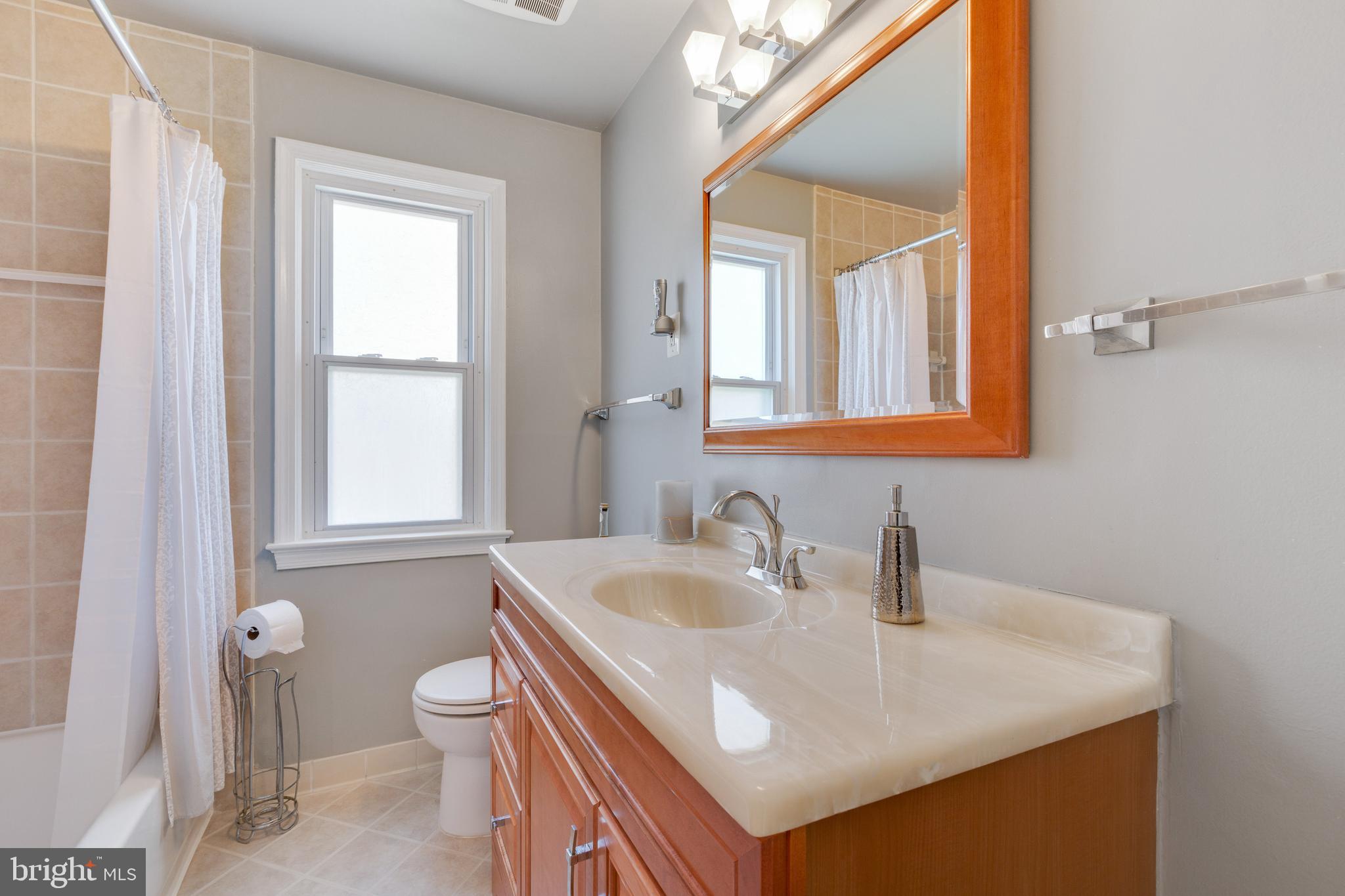 3903 Gannon Road Silver Spring, MD 20902 - Photo 19 of 51 a bathroom with a sink a toilet and a mirror