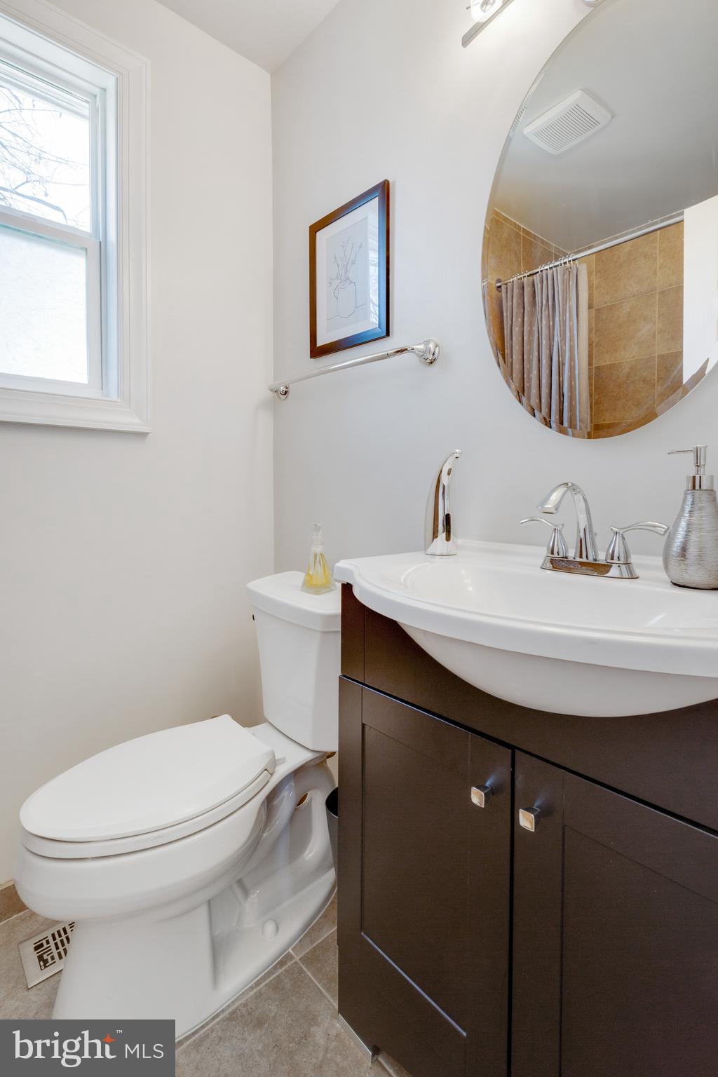 3903 Gannon Road Silver Spring, MD 20902 - Photo 35 of 51 a bathroom with a sink a mirror and a toilet