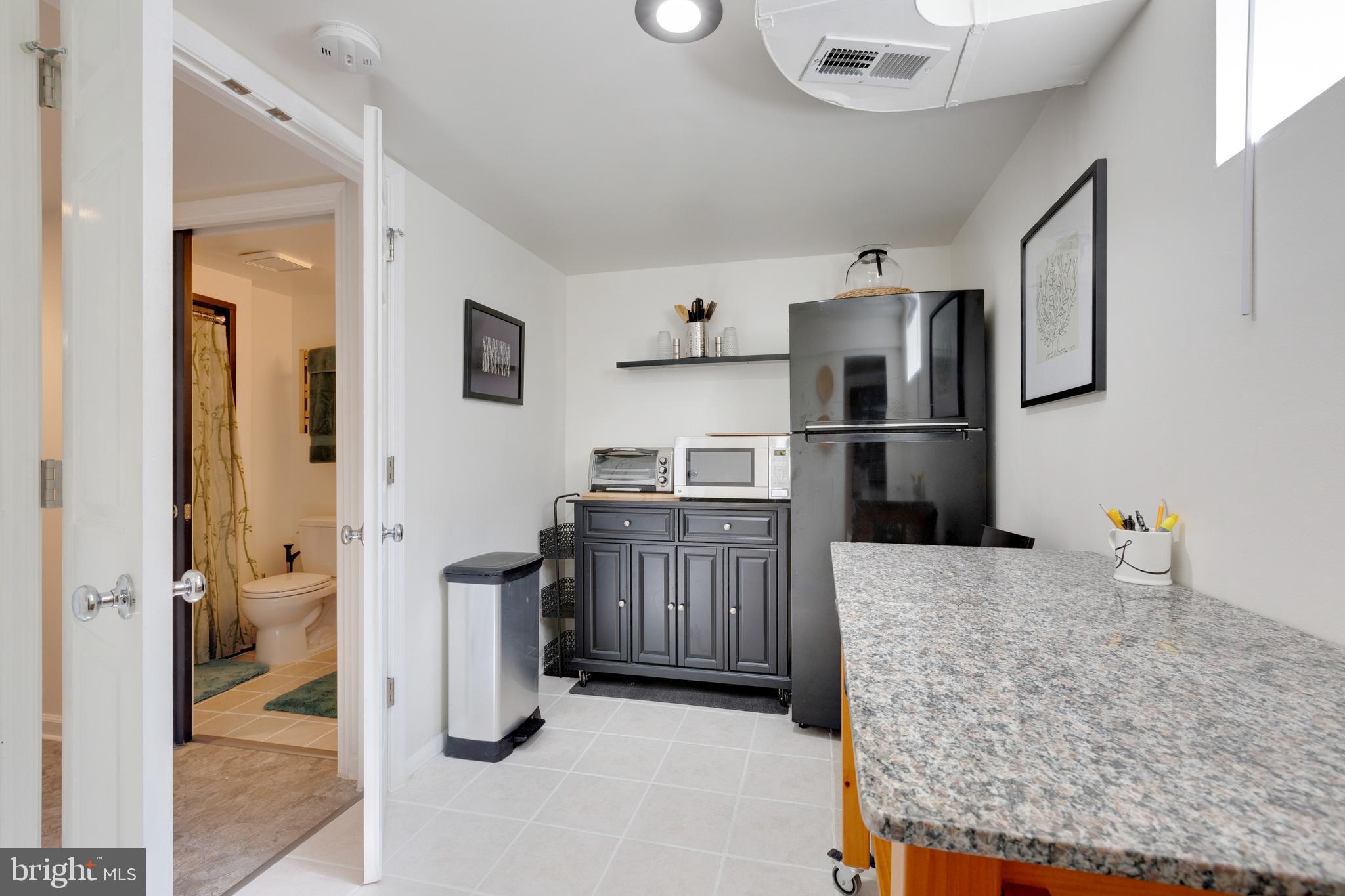 3903 Gannon Road Silver Spring, MD 20902 - Photo 37 of 51 a kitchen with a refrigerator and a sink