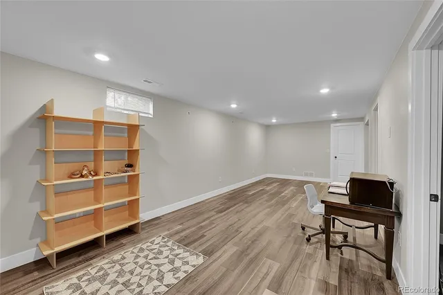 a view of room with wooden floor and cabinet