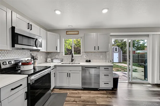 a kitchen with a sink stove and microwave