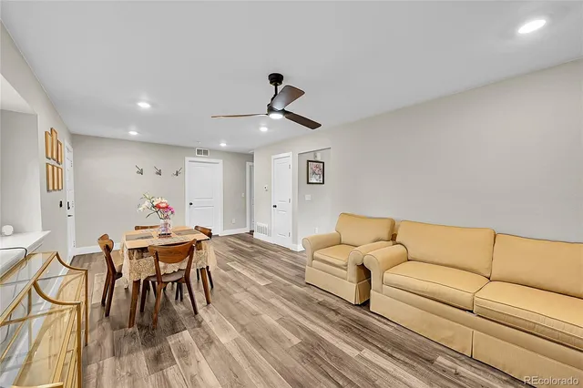 a living room with furniture and wooden floor