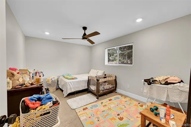 a bedroom with furniture and a rug