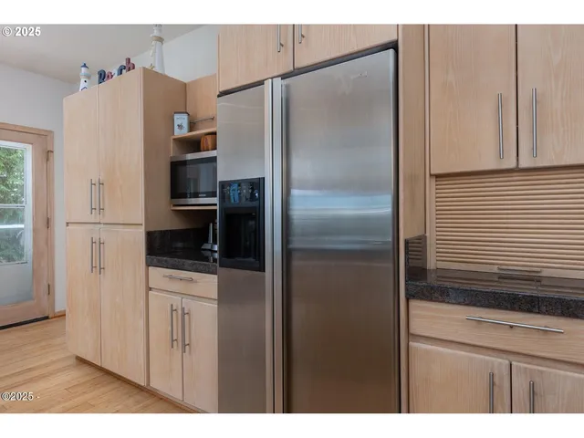 a kitchen with stainless steel appliances a refrigerator and a stove