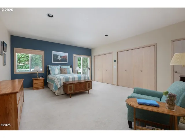 a spacious bedroom with a bed and a couch