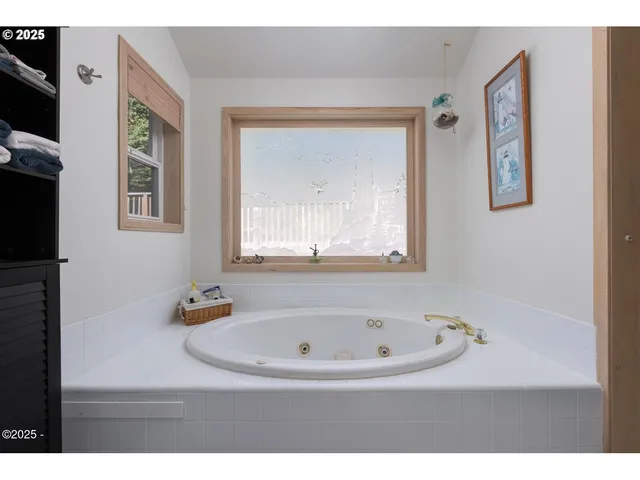 a view of bathroom with bathtub and window
