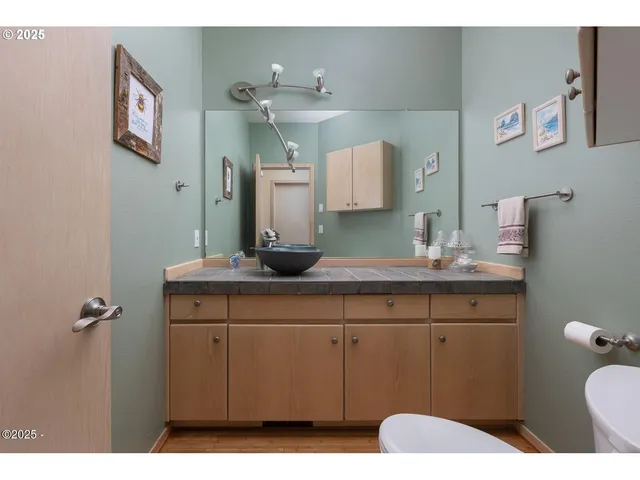 a bathroom with a toilet sink and mirror