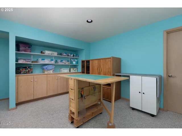 a kitchen with stainless steel appliances cabinets and wooden floor