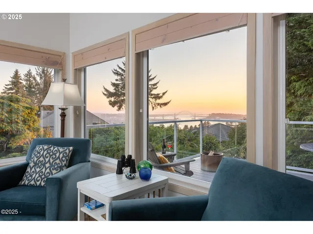 a bedroom with furniture and a large window