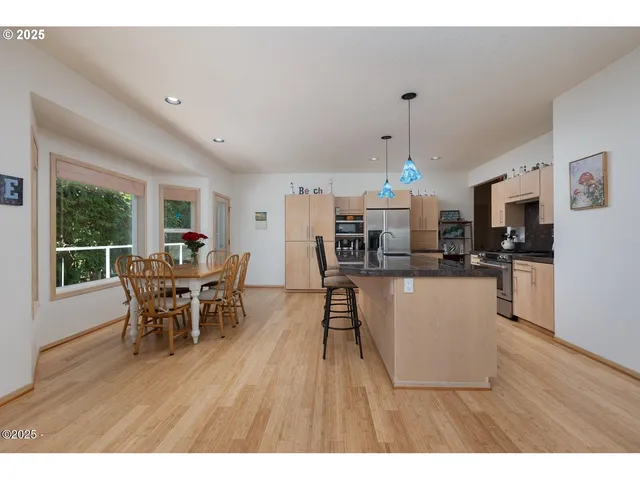 a dining room with furniture and wooden floor
