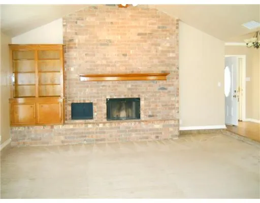 a view of empty room with a fireplace