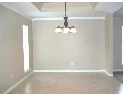 a view of wooden floor and window in an empty room