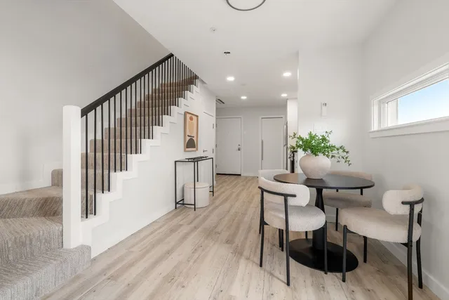 a dining room with furniture and wooden floor