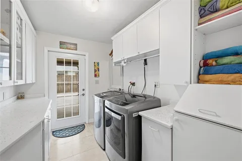 a utility room with closet dryer and washer