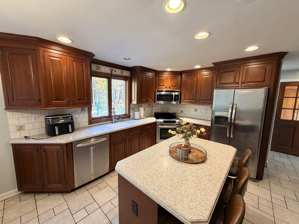 361 South Main Street Bellingham, MA 02019 - Photo 11 of 28 a kitchen with kitchen island a sink appliances and cabinets
