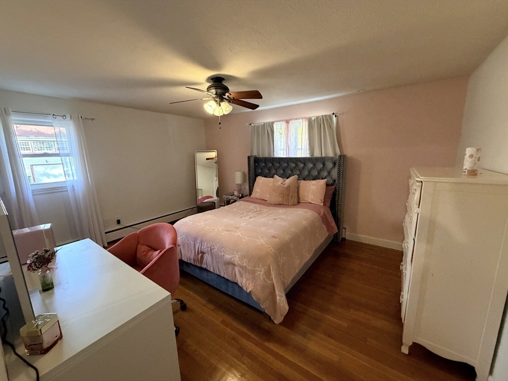 361 South Main Street Bellingham, MA 02019 - Photo 13 of 28 a bedroom with a bed and a chandelier
