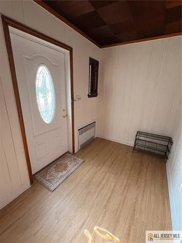 a view of a livingroom with wooden floor and window