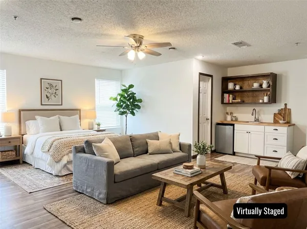a spacious bedroom with a bed and a couch