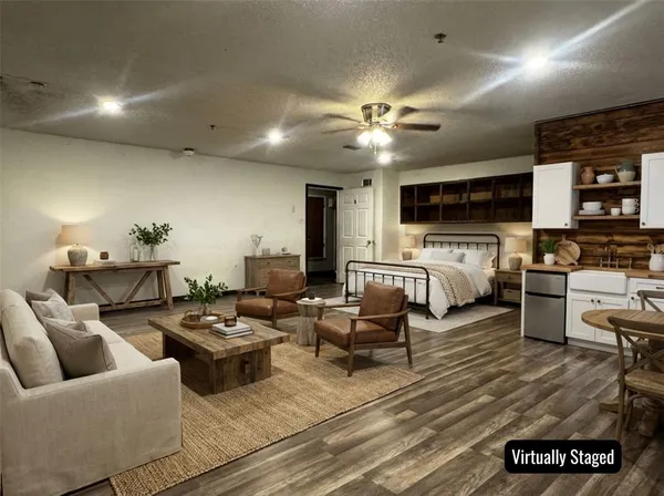 a living room with furniture kitchen view and a flat screen tv